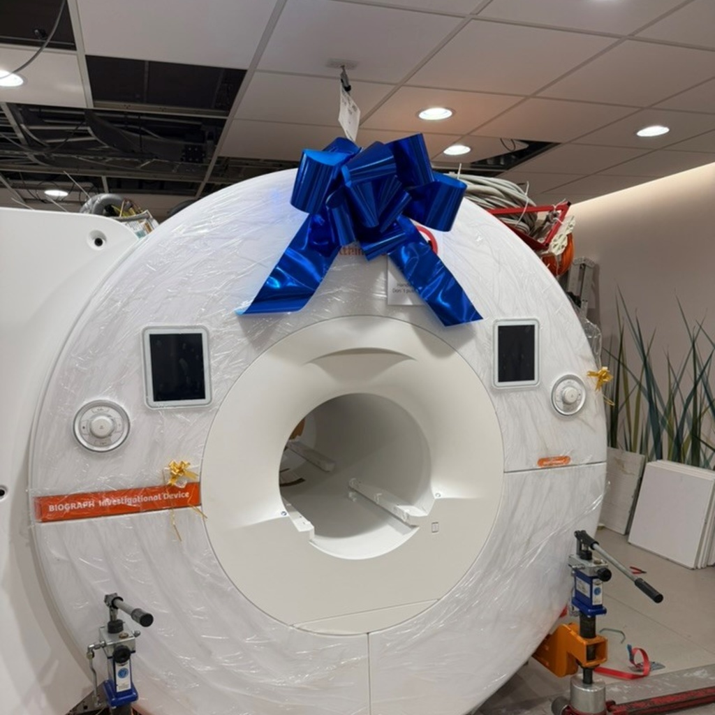 PET/MR scanner wrapped in plastic and topped with a big blue bow.