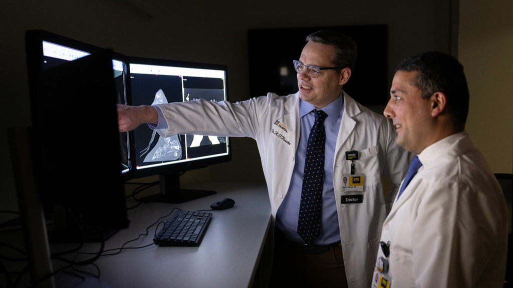 Two radiologists looking at x-rays